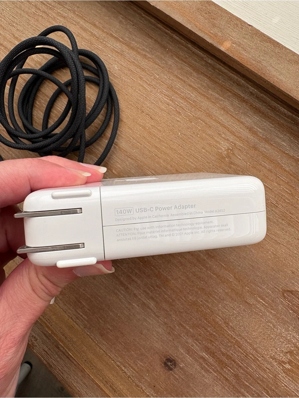 Apple 140w USB-C power adapter and black USB-C to MagSafe charging cord